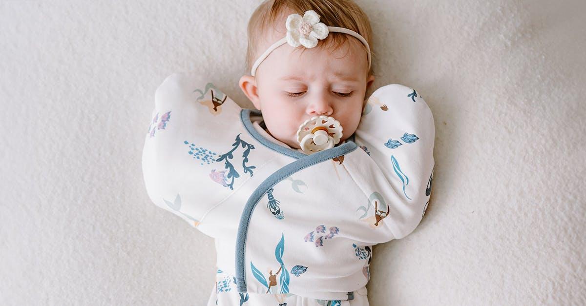 Newborn baby in Nest Designs' startle stop sleep bag